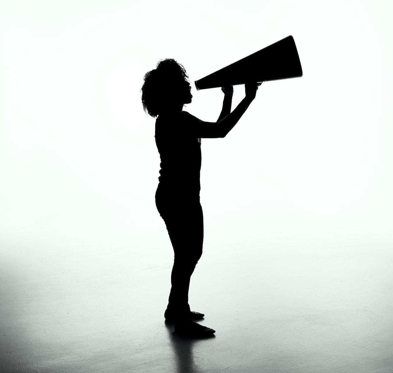 silhouette of woman holding rectangular board